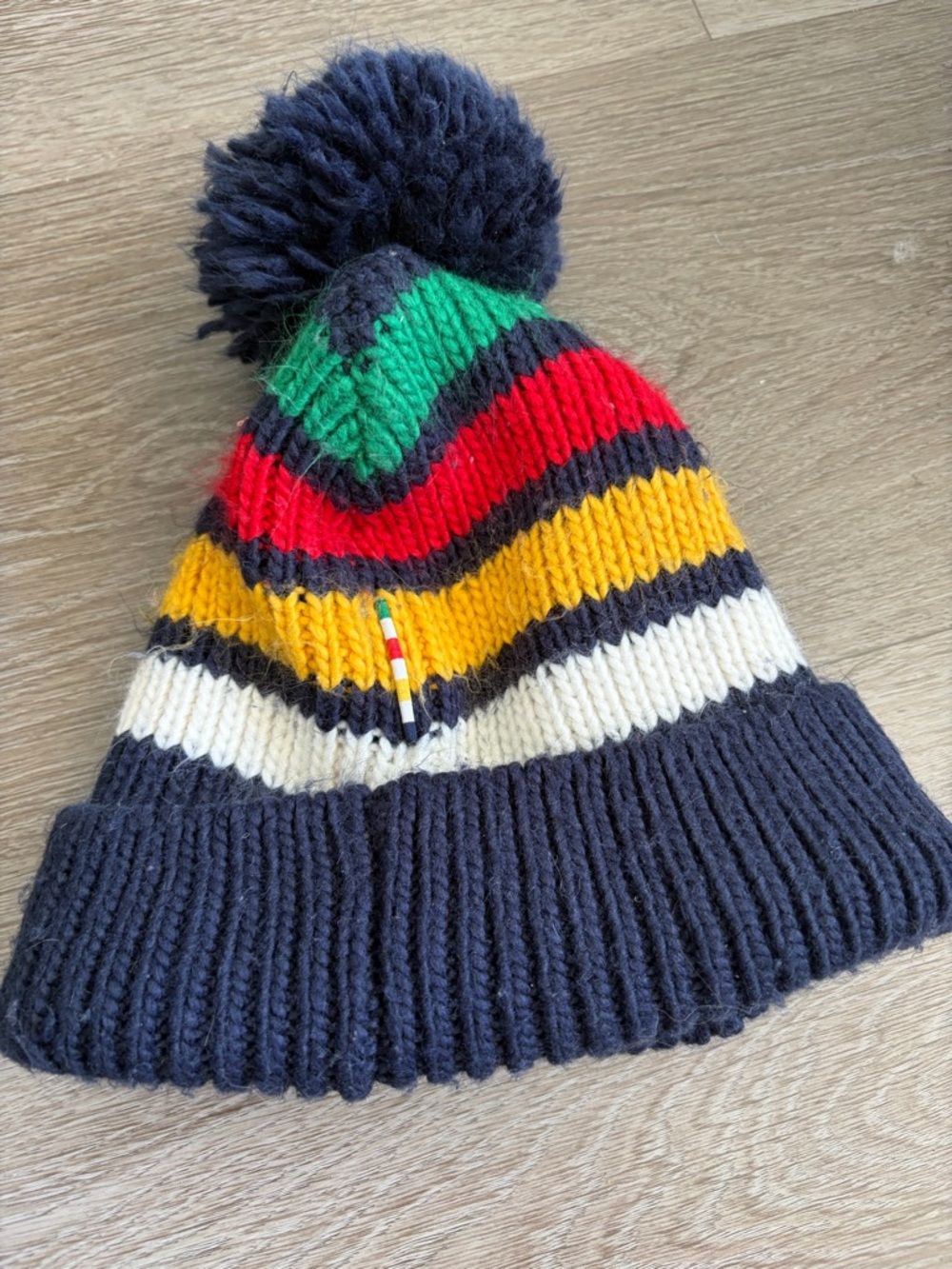 The bay hbc stripes Pom Beanie -‎ Navy with Red, Yellow, Green & White Stripes
